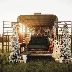 a couch sitting in the back of a truck with christmas decorations on it's sides