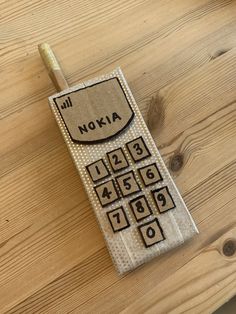 a cell phone sitting on top of a wooden table