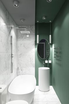 a modern bathroom with green walls and white fixtures on the wall, along with two round sinks