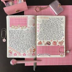 an open notebook with writing on it next to a pink purse and keychain