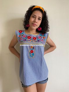 "This adorable Puebla top is perfect for summer, the bright colors and hand embroidered flowers give just the taste of Mexico and summer combined. Rare to find in gingham fabric. Fits size Extra Small Measurements taken flat Armpit to armpit 17 1/2\" Bottom hem width 21 1/2\" Shoulder from bottom hem 24 1/2\"" Summer Cotton Embroidered Top For Fiesta, Summer Fiesta Cotton Blouse, Traditional Sleeveless Tops For Spring, Sleeveless Geometric Embroidered Blouse For Summer, Sleeveless Blouse With Geometric Embroidery For Summer, Cotton Tops With Floral Embroidery For Cinco De Mayo, Sleeveless Geometric Embroidery Summer Blouse, Folk Style Sleeveless Summer Tops, Summer Fiesta Top With Geometric Embroidery