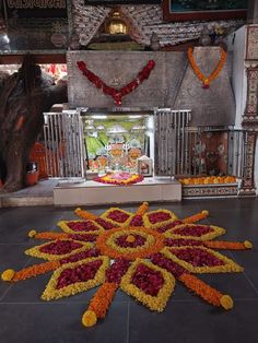 an elaborate flower arrangement in front of a shrine