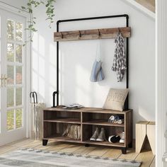 a coat rack with shoes and umbrellas hanging on the wall next to a rug