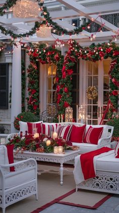 a living room decorated for christmas with red and white furniture