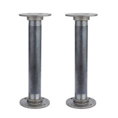 two metal poles are standing next to each other on a white background and one is in front of the camera