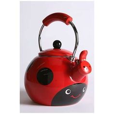 a red tea kettle with a ladybug design on it