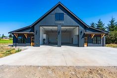 a large gray building sitting on top of a dirt field