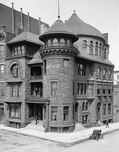 an old black and white photo of a large brick building with two storyed towers