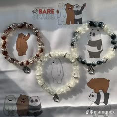 three bracelets with bear and panda charms on them, one is beaded in glass beads