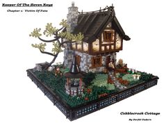 a small house made out of legos on top of a green field with trees