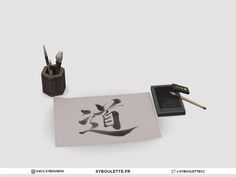 an ink pen and brush sitting on top of a piece of paper with chinese writing