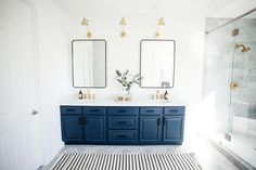 a bathroom with two sinks and mirrors on the wall