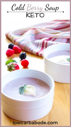 two bowls of cold berry soup on a wooden table