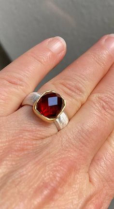 A beautiful, deep red garnet in an unusual shape, rectangular and a great cut. Something else :-) It is set in 750 gold and sits on a silky matt 925 silver ring. The base of the setting is also made of silver to bring out even more light from the stone. To fall in love Made with love in my workshop. garnet 750 gold 925 silver Ring size 55 mm Inner diameter 17.25mm Modern Red Ruby Ring, Modern Red Ruby Ring For Wedding, Modern Red Ruby Wedding Ring, Elegant Red Faceted Ring, Elegant Garnet Rings In Rectangular Shape, Elegant Rectangular Garnet Rings, Modern Garnet Rings For Gift, Rectangular Garnet Rings In Elegant Style, Modern Red Garnet Rings