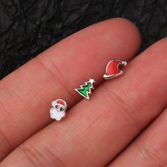 Pick some festive and fun nostril jewelry for this Christmas!These nose studs set includes a Santa's red hat, a green Christmas tree, and a cute Santa charm with a warm red cap and fluffy white beard. Material: Made of durable 316L stainless steel, safe and durable to wear in for a long time. Sizes: Bar Thickness: 20G=0.8mm, Bar Length: 6.5mm. Package: Sold as a set of 3pcs. We strive to bring you the best quality body jewelry for the best prices, along with many new captivating designs introduc Novelty Christmas Jewelry For The Holidays, Christmas Novelty Silver Jewelry, Cute Christmas Festive Jewelry, Novelty Christmas Holiday Jewelry, Christmas Holiday Novelty Jewelry, Cute Christmas Holiday Jewelry, Studs Nose Piercing, Nostril Jewelry, Tiny Nose Studs