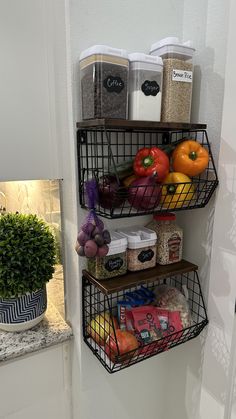 two metal baskets filled with food sitting on top of a wall