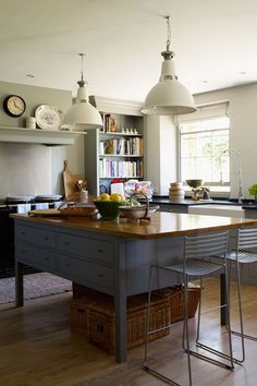 a large kitchen with an island in the middle