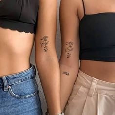 two women with matching tattoos standing next to each other