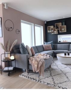 a living room filled with furniture on top of a hard wood floor covered in rugs