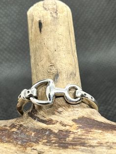 Sterling Silver Horse Snaffle Bit Ring. Lovely ring and beautifully crafted. Top width is 6.5mm and weight is on average 2 grams. We have a strong bond with horses. Many ancient cultures worshipped horses. European and Asian cultures value the nobility and freedom the horse represents. Horse jewellery celebrates the link we share. Horse jewellery symbolizes freedom, expression, and strength. All our jewellery comes gift wrapped in an organza bag Silver Adjustable Horseshoe Rings, Snaffle Bit, Silver Horse, Horse Jewelry, Lovely Ring, Ancient Cultures, Stackable Rings, Organza Bags, Jewelry Rings