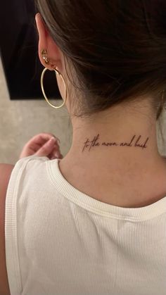 a woman with a tattoo on her neck that reads, the world is not here