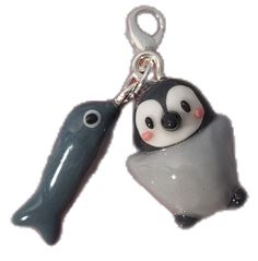 a key chain with a penguin and a fish on it