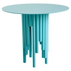 a round table with many thin blue sticks sticking out of it