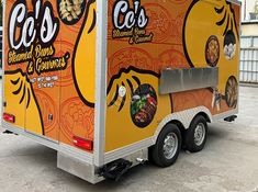 an orange food truck parked in a parking lot