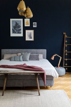 a bedroom with blue walls and wooden floors