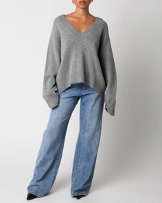 Our Elsie Sweater features a plunging v-neck and a oversized fit. 100% acrylic Made in China Grey Sweater Work Outfit, 60 Year Old Woman Fashion, Sweater Work Outfit, V Neck Grey Sweater, White Tee Outfit, Buckle Bunny, 60 Year Old Woman, Oversize Sweater, Sweater Oversized