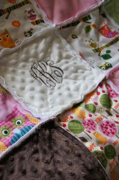 an owl themed baby blanket with the monogrammed name on it's side