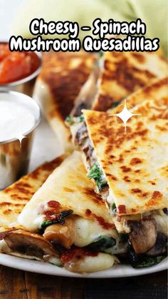 cheese - spinach mushroom quesadillas on a white plate with ranch dressing