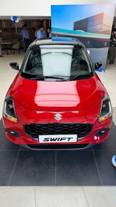 the front end of a red car on display