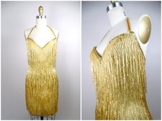 "This is an EXQUISITE 80's-does-20's vintage dress beautifully detailed and hand beaded with fringed glass beading and gold sequins. It's in perfect condition! Bust - 34\" Waist - 26\" Hips - 36\" Length - 34\" This dress comes from a pet-free and smoke-free home. If you would like more info or have any questions, please don't hesitate to ask!" 1920s Style Fitted Dress With Beaded Fringe, Vintage Beaded Fringe Flapper Dress For Party, Vintage Beaded Fringe Flapper Dress For Evening, Vintage Cocktail Flapper Dress With Beaded Fringe, Vintage Fitted Dress With Fringe, Fitted Vintage Dresses With Fringe, Vintage Cocktail Dresses With Beaded Fringe, Vintage Sleeveless Dress With Beaded Fringe, Fitted Vintage Dress With Beaded Fringe