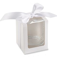 a small white box with a ribbon on the side and a wine glass in it