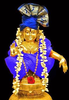 a golden statue with a blue headdress on it