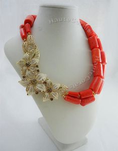 "The beauty of natural corals accented with Gold gives this necklace an authentic African traditional feel. Coral necklaces are a staple in most West-African attire, and this statement coral necklace represents just that! What You Need to Know - Handcrafted Necklace is 17-19inches length - 2 strands of Genuine Coral barrel beads - Matching pair of earrings are 3.5inches - Accented with Gold plated pendant (3 inches) - Miniature gold Czech glass beads separate coral beads - Due to natural nature Spring Jewelry Trends, Statement Wedding Jewelry, African Beads Necklace, Coral Accents, Necklace African, Coral Beads Necklace, Coral Bracelet, Spring Jewelry, Nigerian Wedding