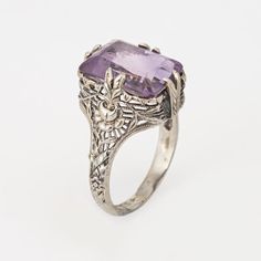 Stylish and finely detailed Art Deco amethyst ring crafted in 18 karat white gold (circa 1920s to 1930s).  Amethyst measures 12.5mm x 8.5mm. Note: light surface abrasions to the amethyst (visible under a 10x loupe).  The square cut amethyst is perched upon a filigree gallery. Charming & intricate pierced floral motifs make this a great for wear during the day or for a glam evening look. The medium rise ring (7mm - 0.27 inches) sits comfortably on the finger.   The ring is in good condition and was recently light cleaned and polished.   Particulars:  Weight: 3.7 grams  Stones:  Amethyst measures 12.5mm x 8.5mm. Note: light surface abrasions to the amethyst (visible under a 10x loupe).  Size & Measurements: The ring is a size 5 1/2 (sizable). The mount measures 12.5mm in length (0.49 inches) Masonic Jewelry, Russian Jewelry, Bijoux Art Nouveau, Detailed Art, Antique Jewelry Rings, Nouveau Jewelry, Jewelry Mens, Art Nouveau Jewelry, Ring Crafts