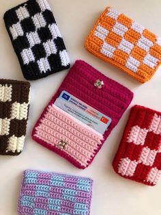 four crocheted wallets sitting next to each other