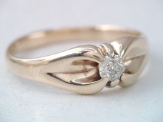 a gold ring with a diamond in the center