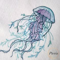 a close up of a piece of cloth with a jellyfish embroidery design on it