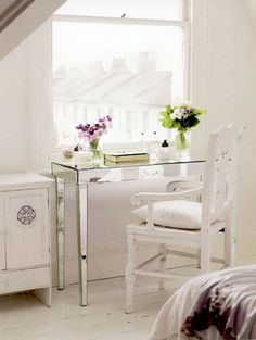 a bedroom with a desk and chair in it