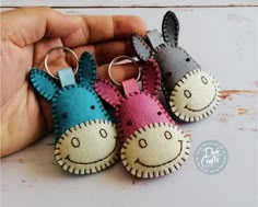 three little stuffed animals are in the shape of keychains