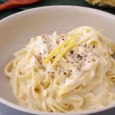 a white bowl filled with pasta and cheese