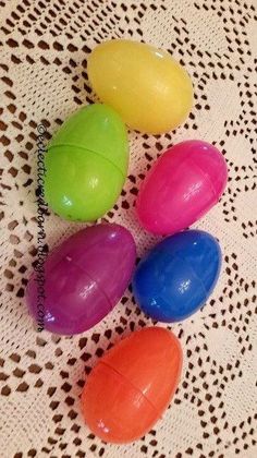 four plastic eggs sitting on top of a table