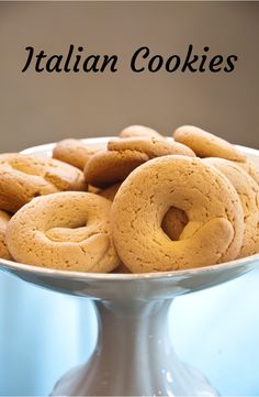 there are many cookies in the bowl on the table with words above it that read italian cookies