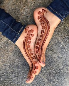 two feet with henna designs on them