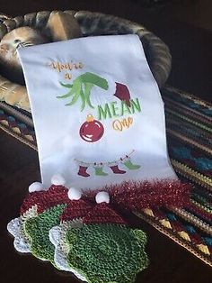 three christmas stockings are sitting next to each other on a table with an oven mitt