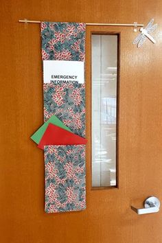 an emergency door hanger is decorated with candy canes and red, green, and blue paper