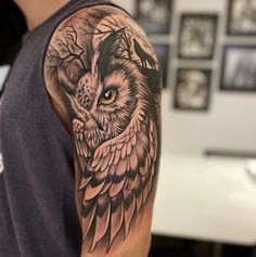 an owl tattoo on the arm and shoulder